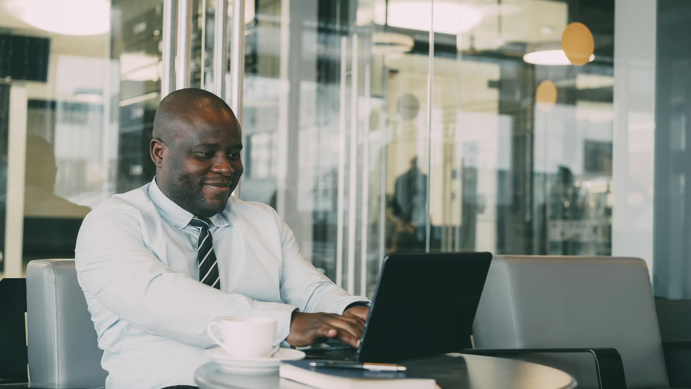 An executive working on a laptop in a modern office
